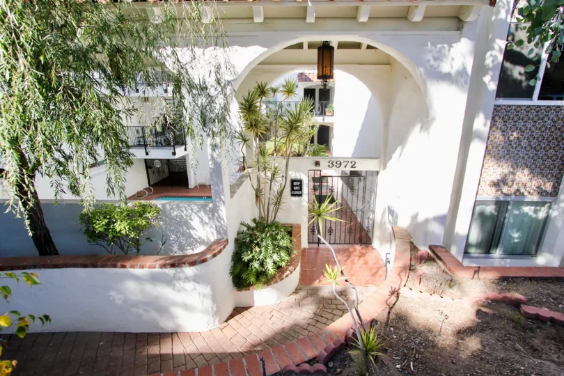 Grand entrance to the Villa Bahia complex with pool in Mission Hills, California