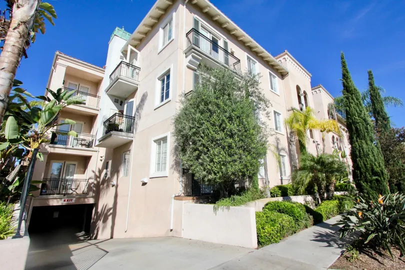 The corner of the building and parking exit of Villa Portofino on Front in Mission Hills, California
