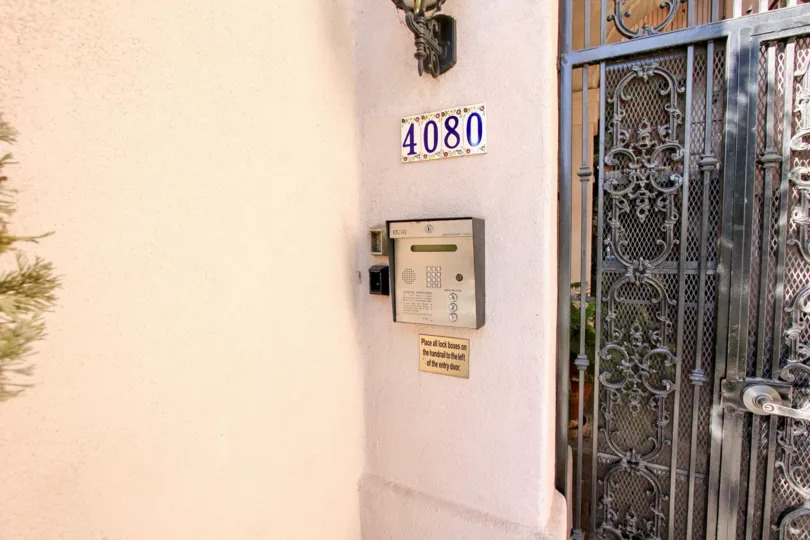 A gate with a street number and intercom at Villa Portofino on Front, Mission Hills, CA