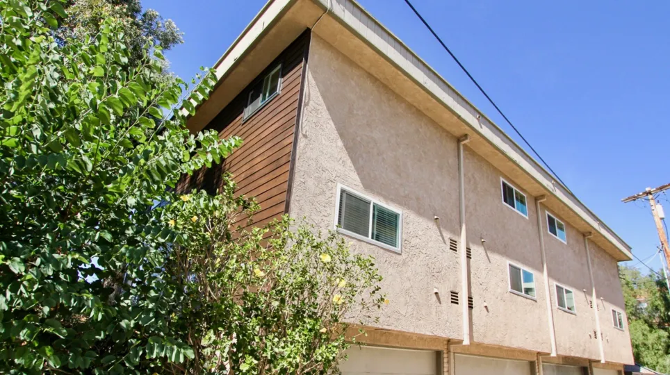 Garage parking with wooden style compound side wall in West Walnut.