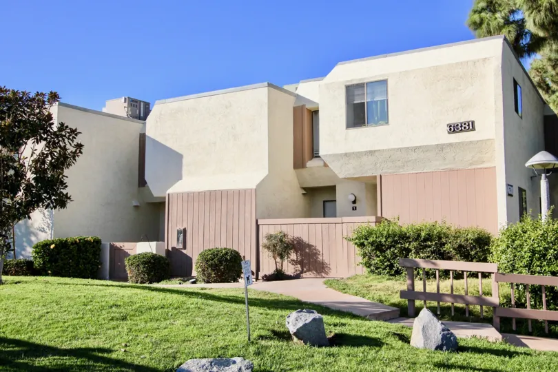 Two story apartment building with a nice patch of grass out front.