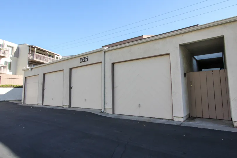 Front entry gate and 4 garages at unit number 6347 on an unknown street in the Cerro De Alcala community in Mission Valley, California