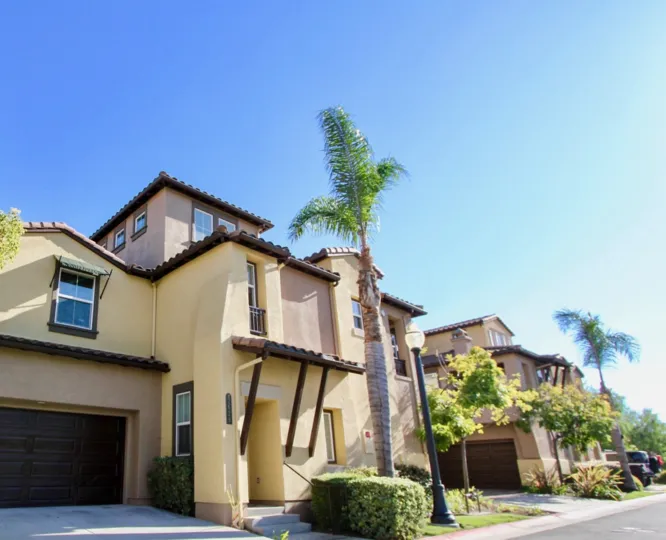 The Courtyards at Escala in Mission Valley, California are beautifully modernized multi-level homes with tall palm trees and green shrubbery surrounding them