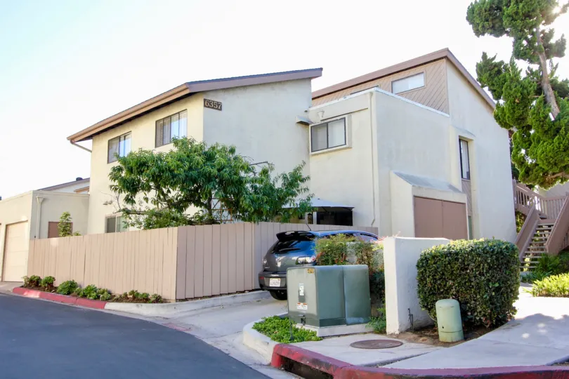 Secluded corner lot with lots of windows and greenery at Friars Mission in Mission Valley, California.