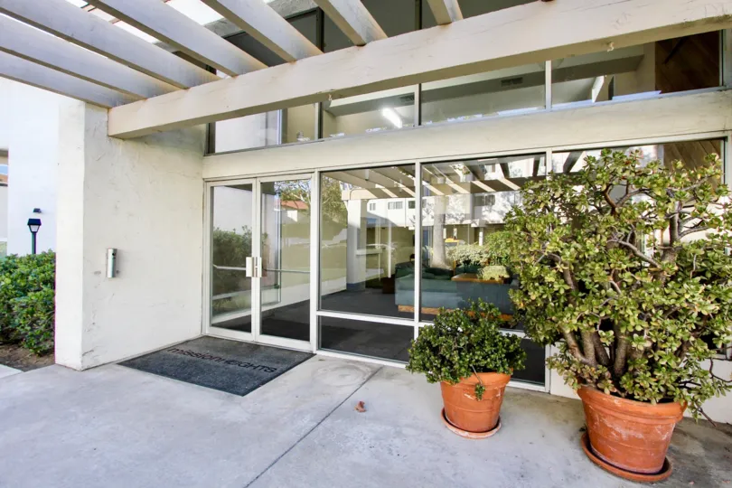 An Entry way with Potted Trees at the Mission Heights.