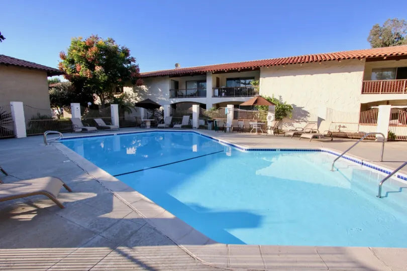 A swimming pool at the Mission Plaza neighborhood, with chairs scattered around