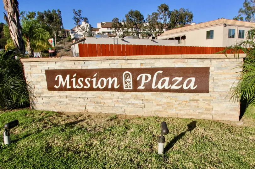 Entrance of Mission Plaza in Mission Valley California with homes and trees in the background