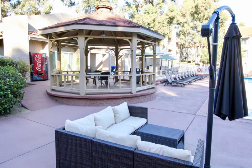 Poolside area with chairs and a white gazebo in Mission Ridge, California