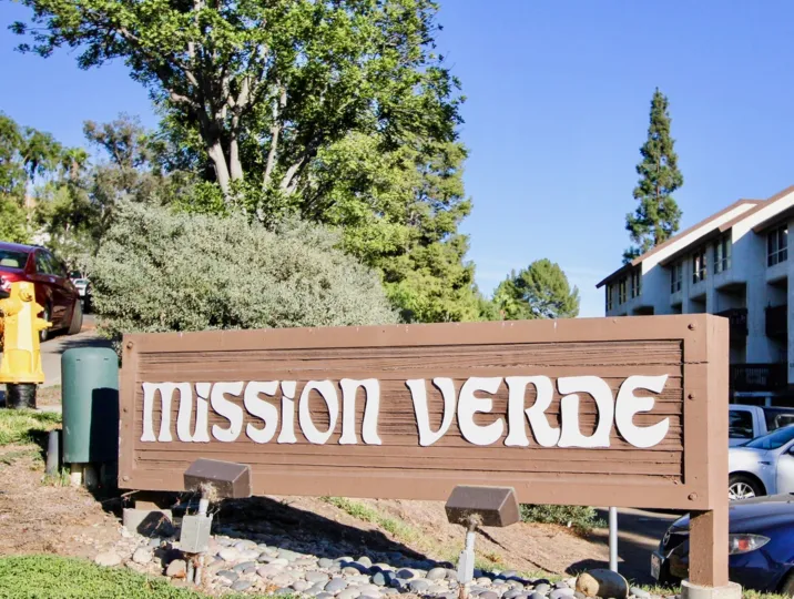 Mission Verde entrance including landscape, buildings, and parking area.