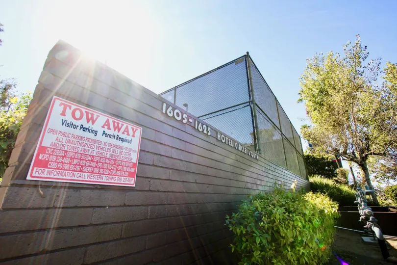 A sunny day in the area of Mission Village, tow away dign, windows, trees, statue