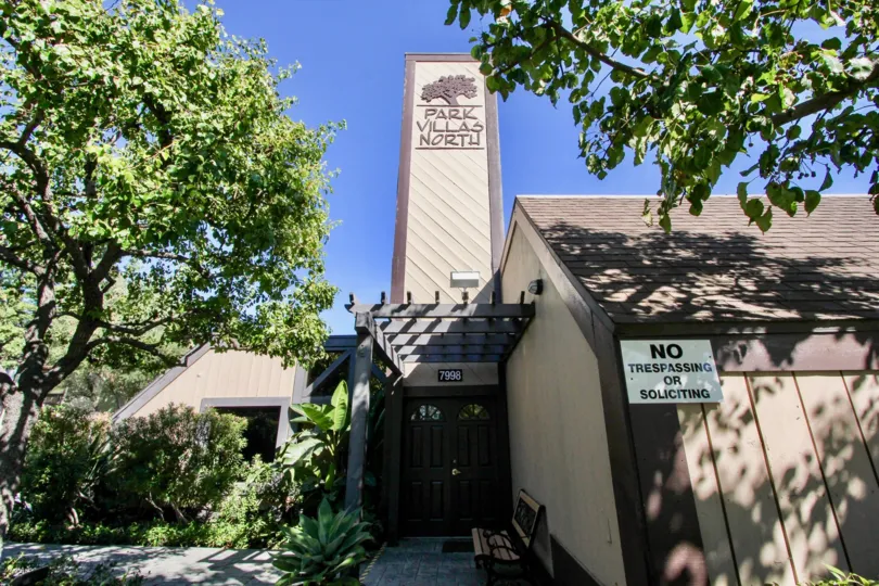 Lush trees and front landscaping of entrance to Park Villas North residence in Mission Valley.