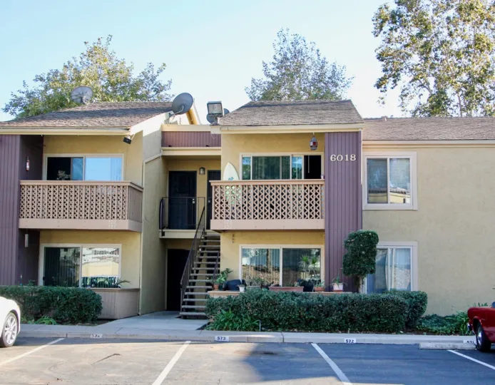 A sunny day in the area of Rancho Mission Villas, balcony, stairs, door, bushes, trees