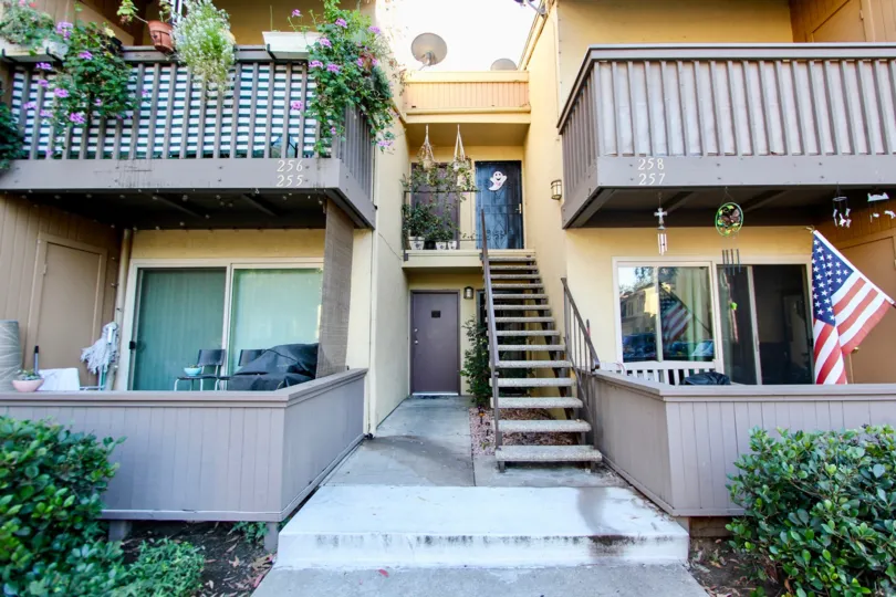The exterior view of one of the buildings of Rancho Mission Villas, with plants and other ornaments