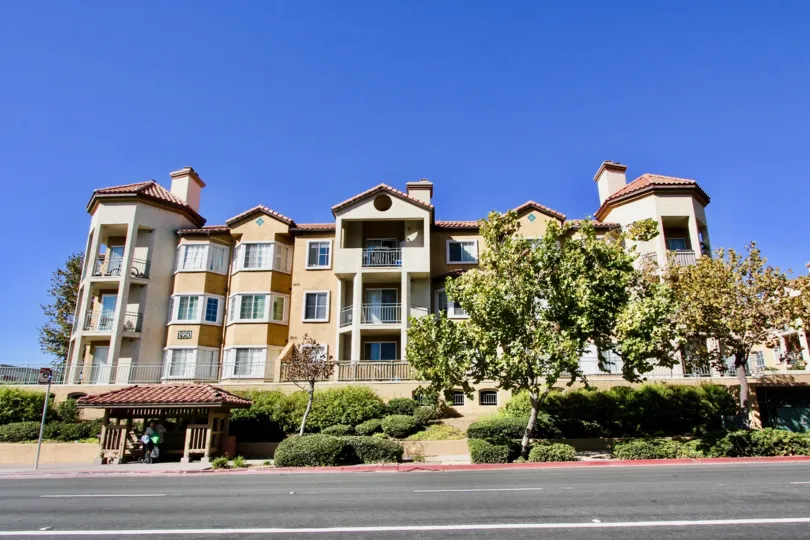 A three story property with porches on a clear day in River Colony