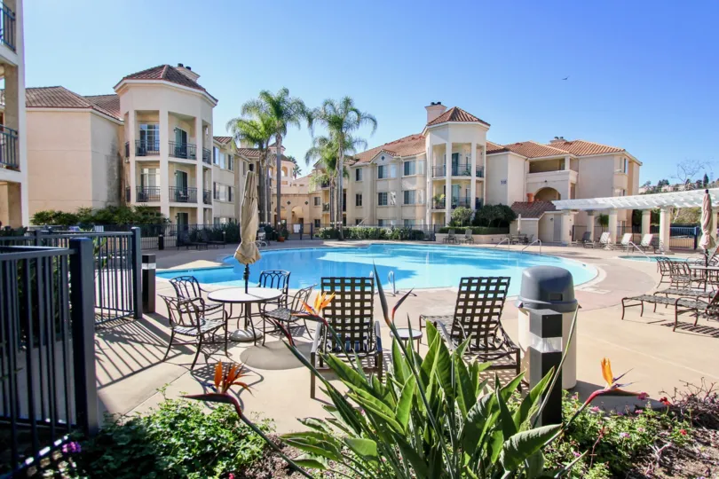 River Scene Community Mission Valley California poolside apartments palm trees tables and seating decorative plants