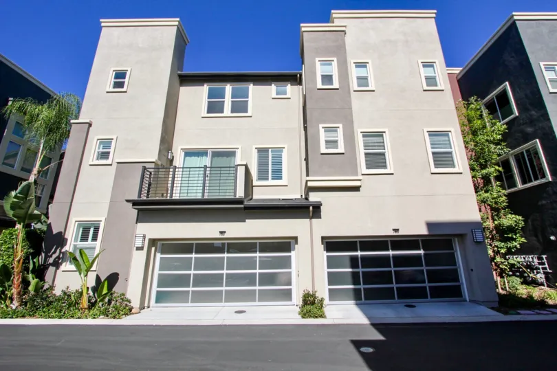 A single balcony sits on the front of a modern building at the Skyloft at Origen condos