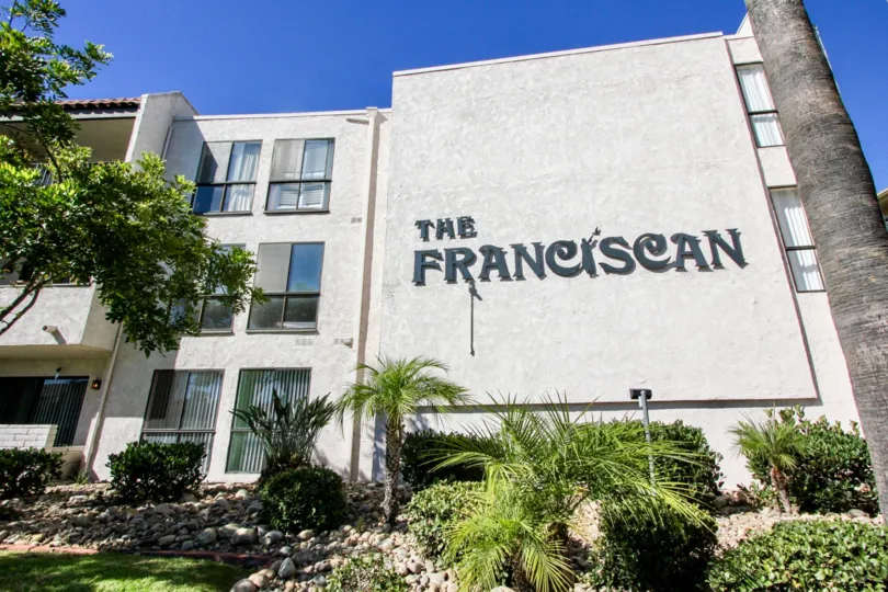 Outside of The Franciscan located in Mission Valley, CA showing logo on the front of building