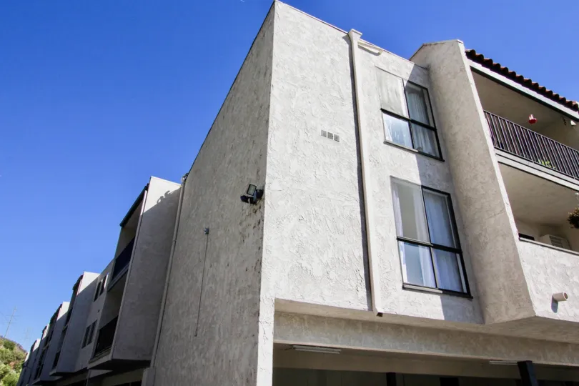 Three story gray units with parking inside Teh Franciscan at Mission Valley CA