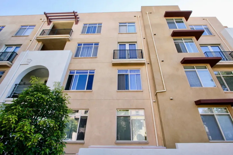 The Lido community in Mission Valley, California; a four story residential community with stucco walls and blue sky.