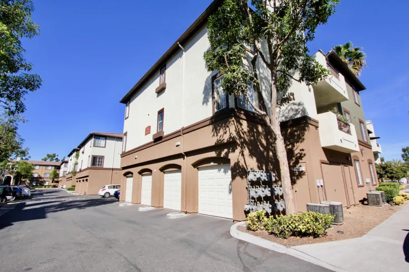 The Missions at Rio Visa housing in Mission Valley, California features first floor garages and palm trees
