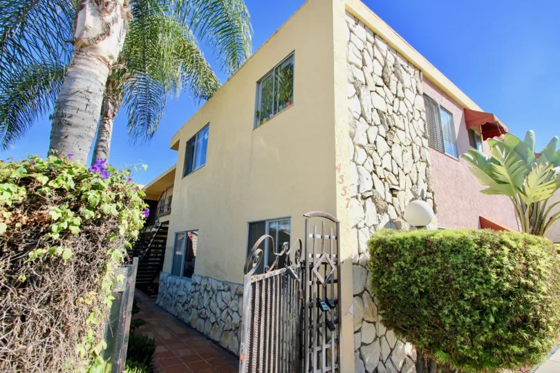 THE BUILDING IN THE 33RD STREET MANOR WITH THE STEEL GATE, BANANA TREE, PLANTS, UPSTAIRS
