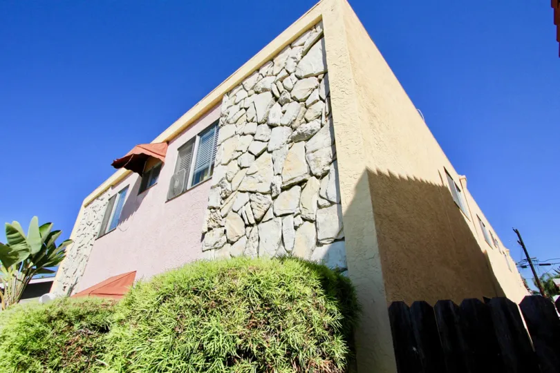 Stone walls of 33rd Street Manor is the distinction of her building. Only in Normal Heights, California