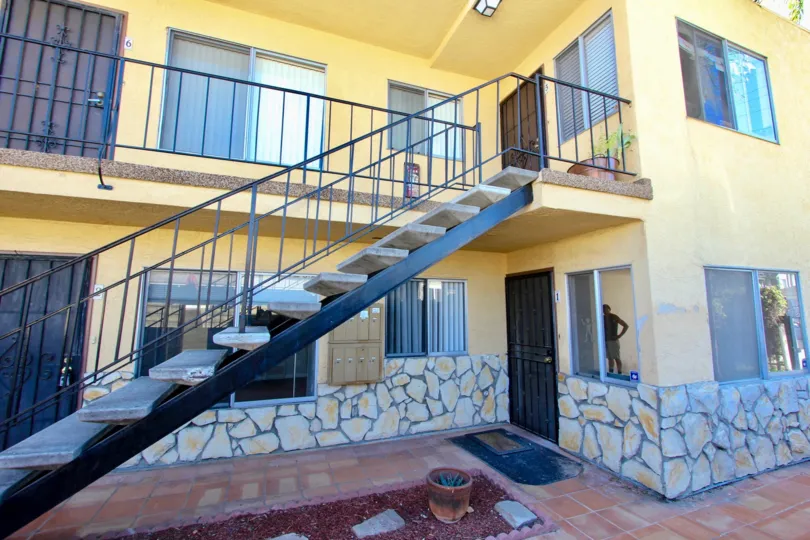 A stairs of a yellow apartment complex in 33rd Street Manor community