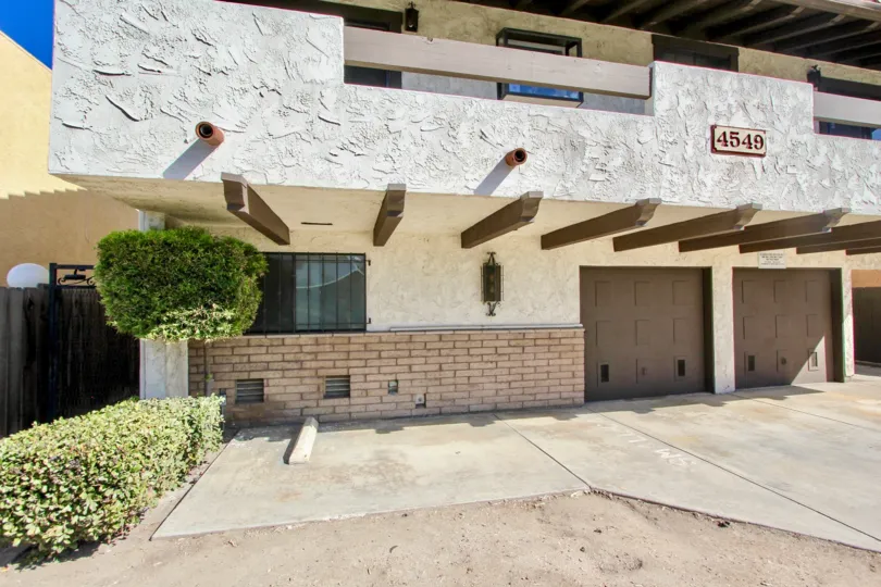 A well built spacious car parking with beautiful lawn in front view of house in 33rd Street North of Normal Heights