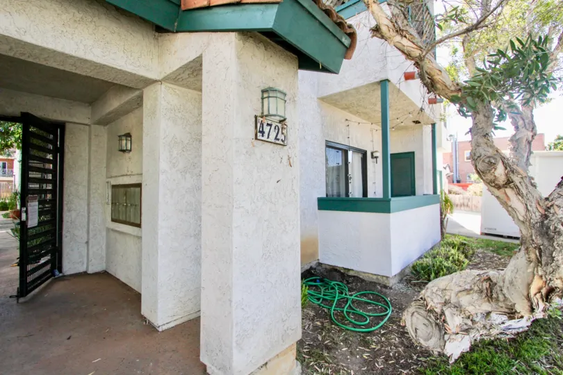 A sunny day in the area of 34th Street Villas, outside, hose, tree, door, entrance condos