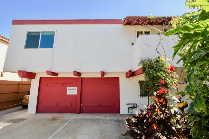 Two red garage doors with a white sign at 4753 35th St in Normal Heights CA