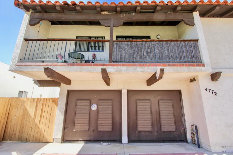 Wooden truss balcony with wooden entrance doors in 4772 36th St.