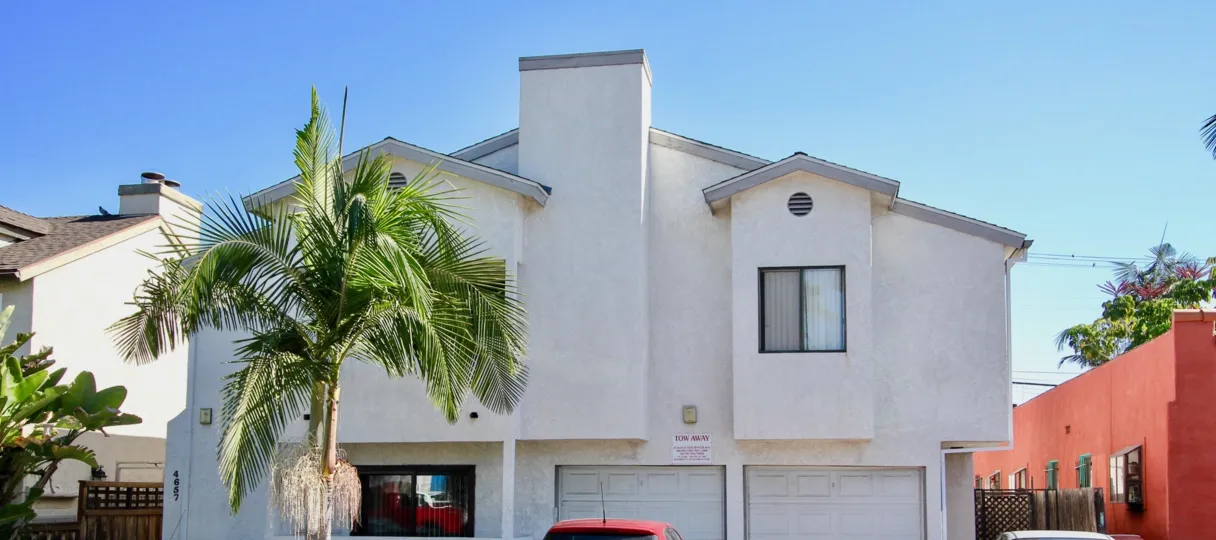 Two story white house with a gray roof at A2L Condominiums in Normal Heights CA