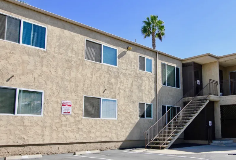 A sunny day in the area of Adela, stairs, condos, palm tree, windows, door