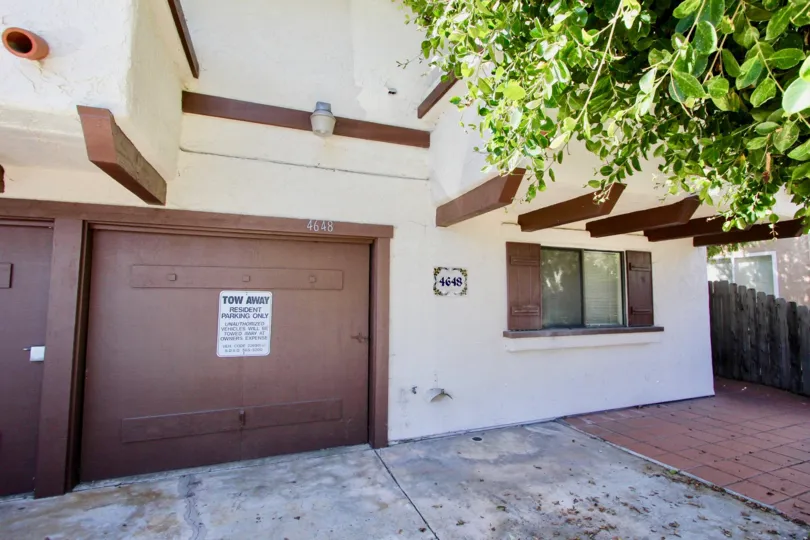 view of a house parking garage in Aspen Villas with a tow away sign on the door