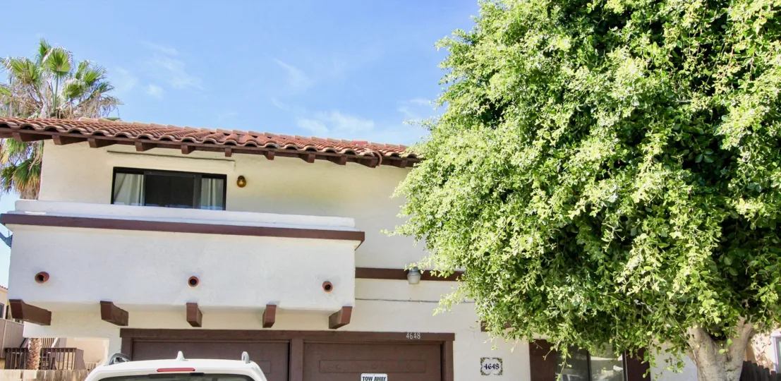 A sunny day in the area of Aspen Villas, outside, garages, trees, car, window