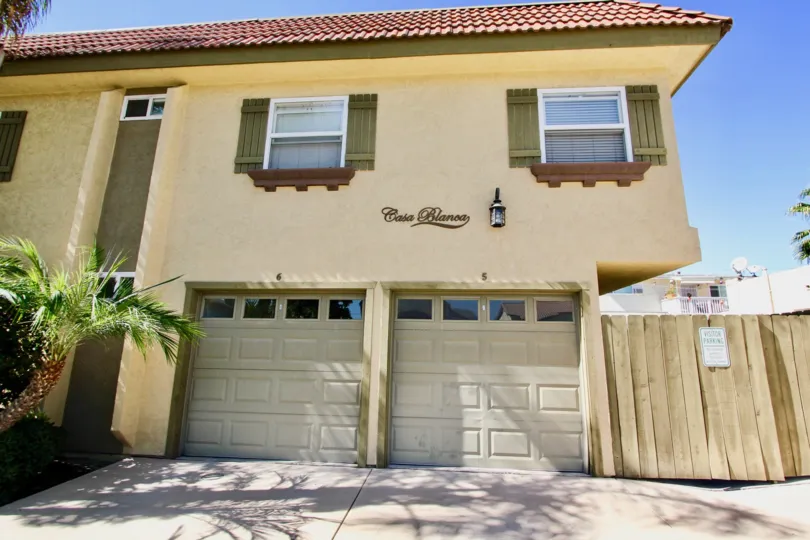 Two garage doors sit below units at the Casa Blanca Villas community of Normal Heights, California.