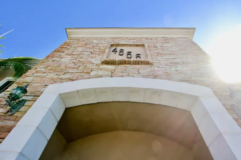 Stunning archway with decorative address plaque and light sconces at Casa Bonita