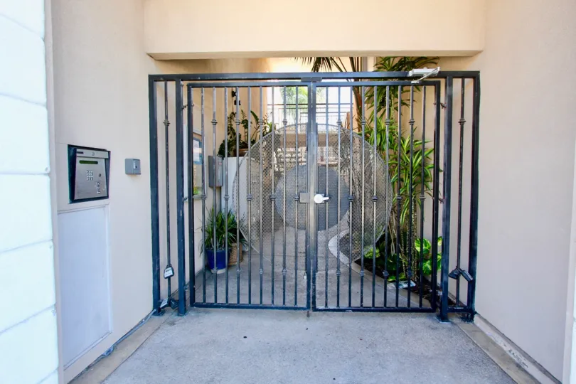 A gated entrance in Casa Bonita community painted in bluish gray color.