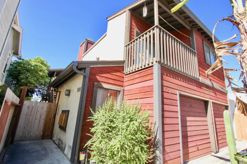 THE BUNGALOW IN THE CASA HEIGHTS WITH THE WOODEN DOOR, METER BOX, TREES, BALCONI, WINDOW