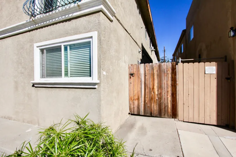 Side entrance with wooden gate of City Lights in Normal Heights, Ca.