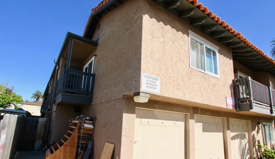 Back of apartments with three garages at Cleveland Avenue Condos in Normal Heights, Ca.