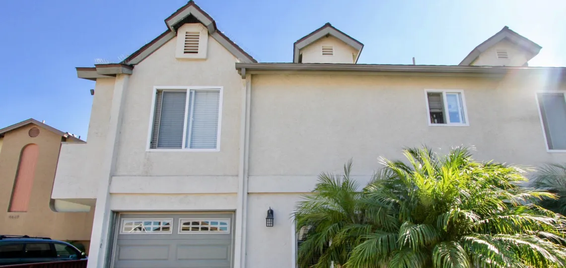 A sunny day in the area of Element on Iowa, outside, ferns, garage, car, balcony, windows