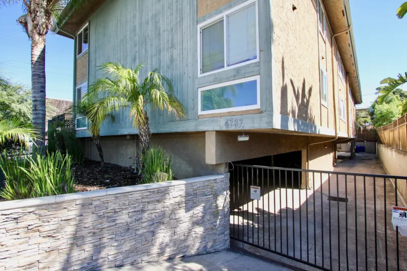 Driveway and gated parking garaged with iron gate at Felton Place in Normal Heights, Ca.