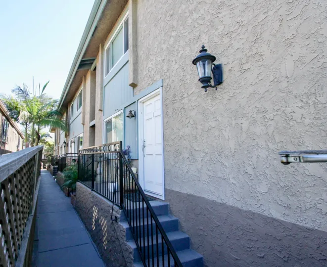 A sunny day in the area of Felton Place, outside, porch, stairs, porch light, condos, palm trees