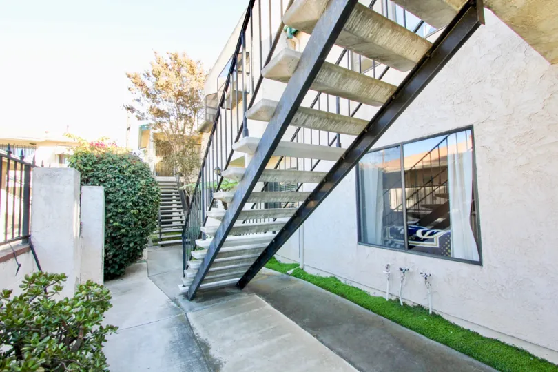 A sunny day in the area of Hamilton Street Condos, outside, bush, stairs, window, curtain