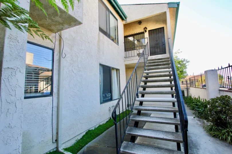 Staircase to upstairs apartment with bars on the window at Hamilton Street Condos in Normal Heights, Ca.