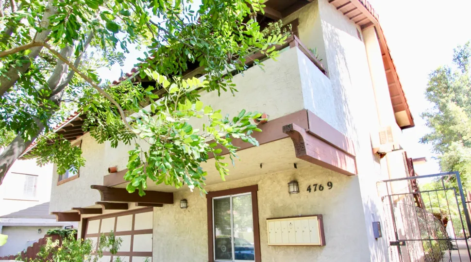 Corner view with trees and gate of Hawley Blvd Condos residence, Normal Heights, CA