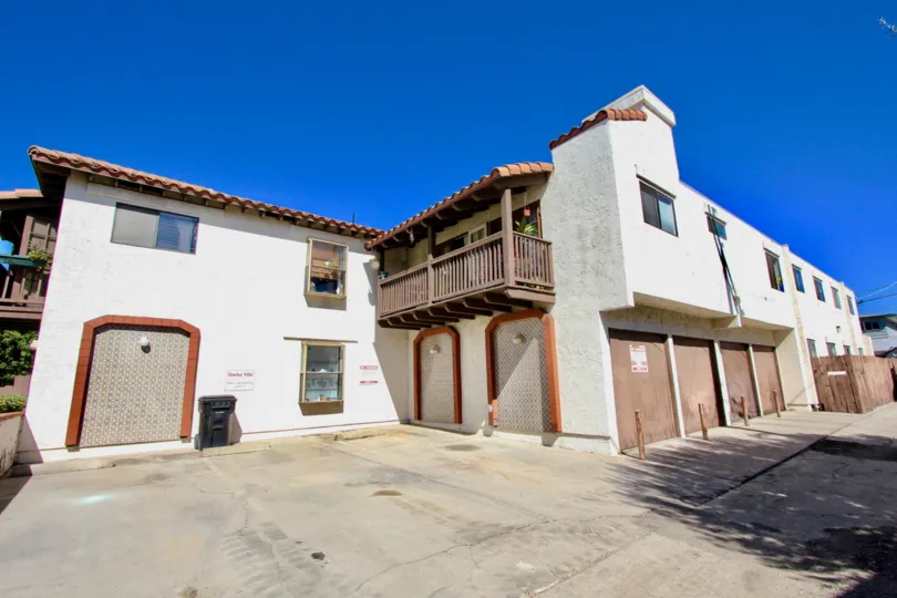 A sunny day in the area of Hawley Villas, parking lot, garages, balcony, flower, window