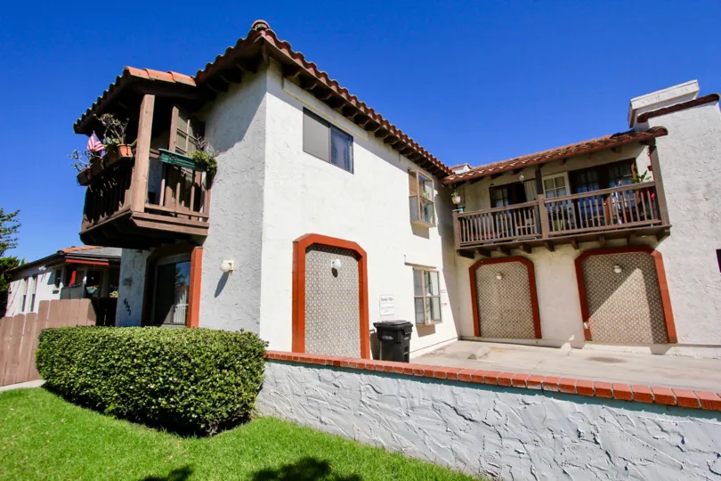 A sunny day in the area of Hawley Villas, outside, bush, brick, driveway, garage, balcony