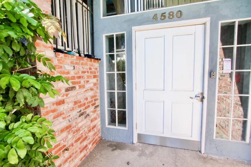 Short white door with address above it at the Madison Ave in Normal Heights CA